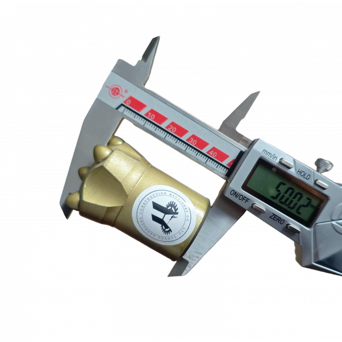 Close-up view of 36mmÃâ50mm tapered button bit showing carbide teeth and steel construction